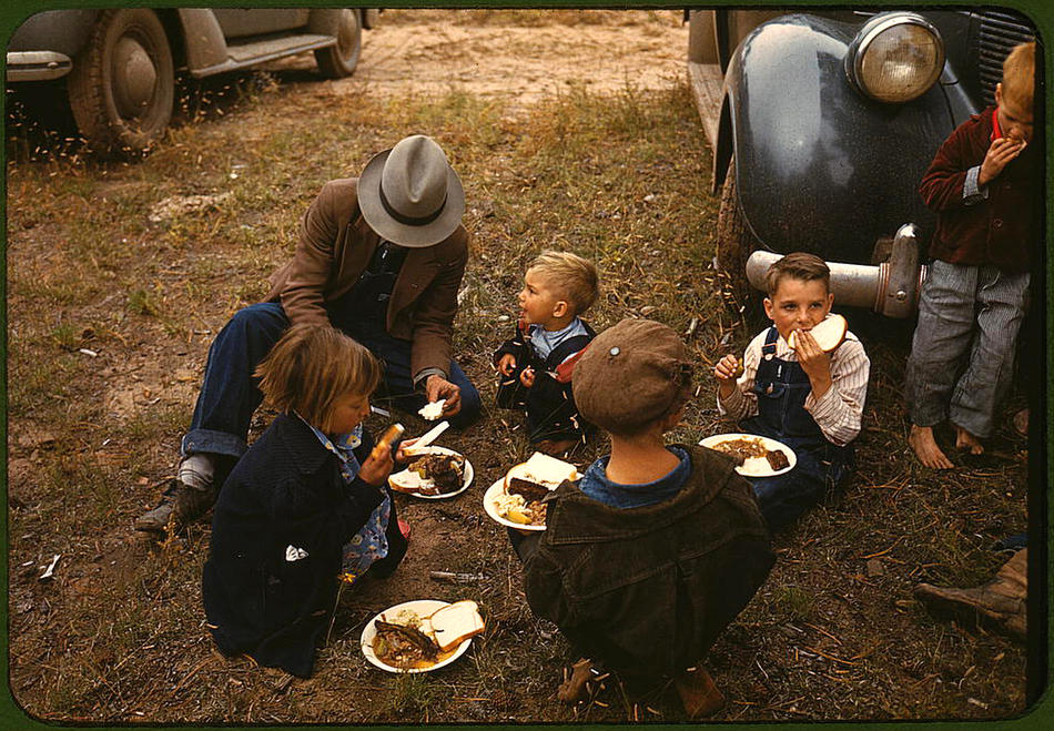 Homesteader and his children eating barbeque at the New Mexico Fair
